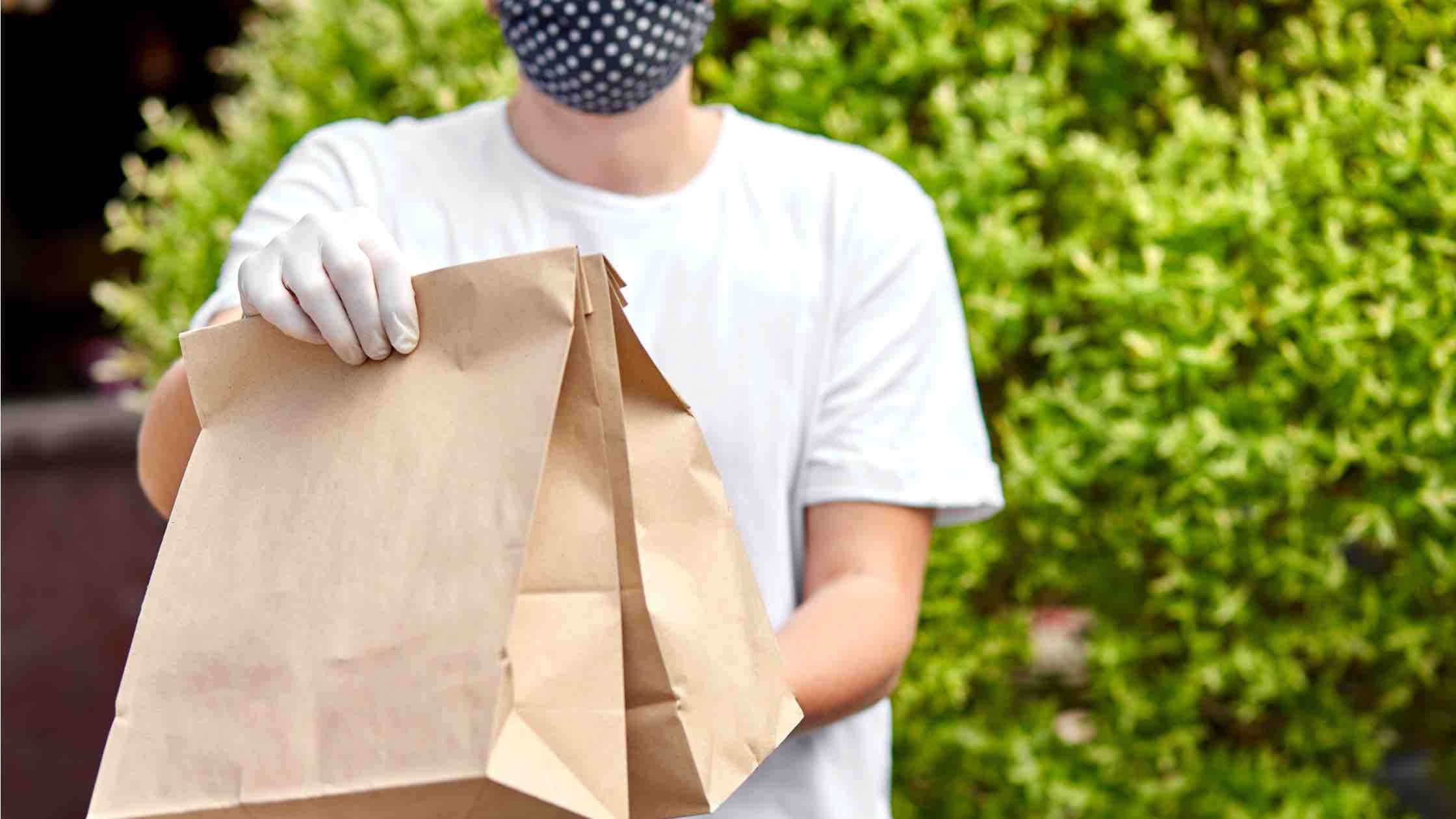Restaurant courier holding food delivery